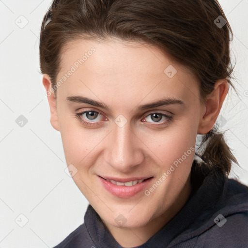 Joyful white young-adult female with medium  brown hair and grey eyes