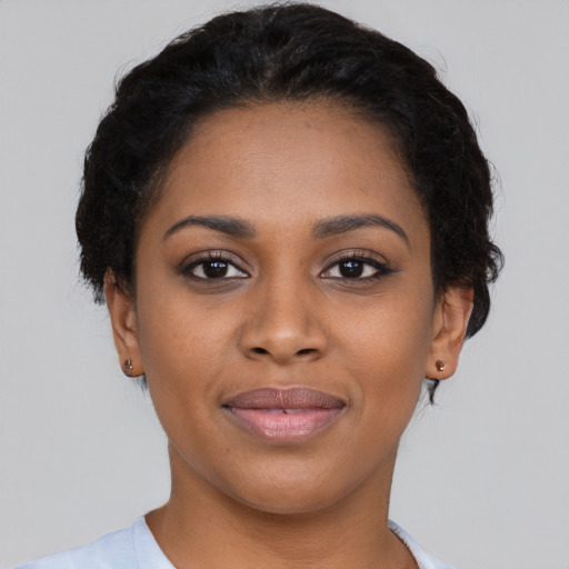 Joyful black young-adult female with short  brown hair and brown eyes