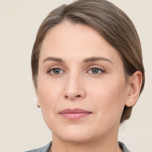 Joyful white young-adult female with medium  brown hair and grey eyes