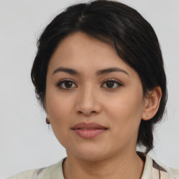 Joyful latino young-adult female with medium  brown hair and brown eyes