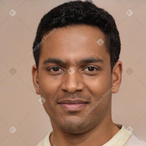 Joyful black young-adult male with short  black hair and brown eyes