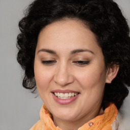 Joyful white adult female with long  brown hair and brown eyes