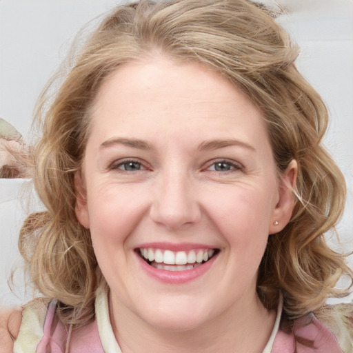 Joyful white young-adult female with medium  brown hair and blue eyes