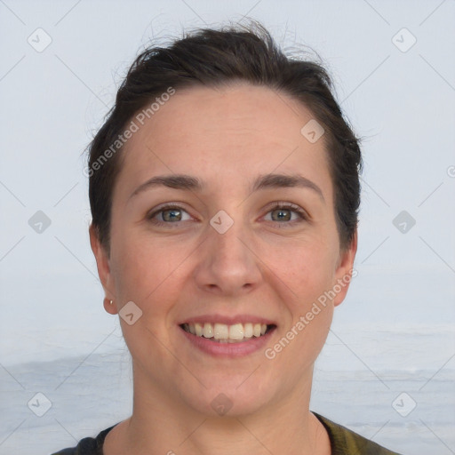 Joyful white adult female with short  brown hair and grey eyes