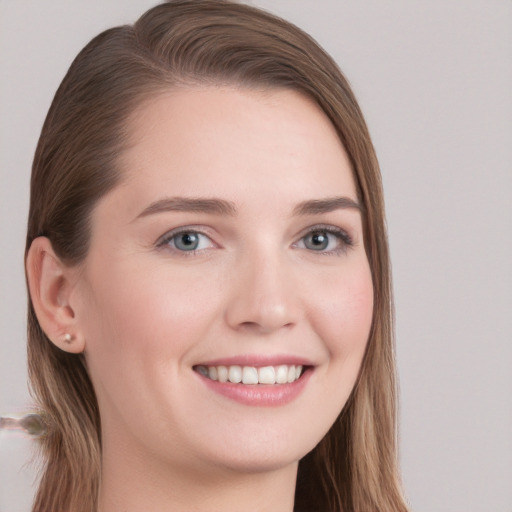 Joyful white young-adult female with long  brown hair and grey eyes