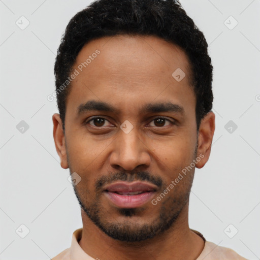 Joyful black young-adult male with short  black hair and brown eyes