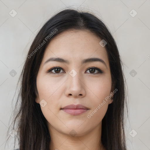 Joyful latino young-adult female with long  brown hair and brown eyes