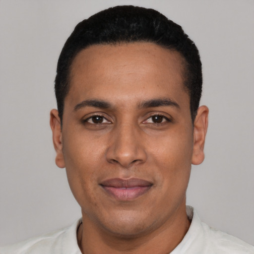 Joyful latino young-adult male with short  black hair and brown eyes