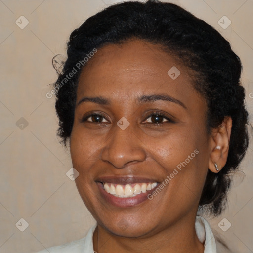 Joyful black adult female with medium  brown hair and brown eyes