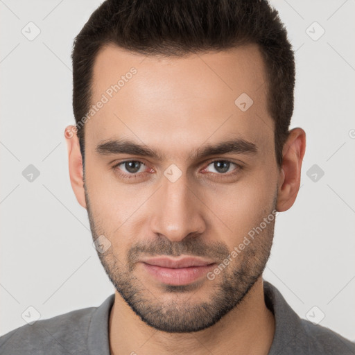 Joyful white young-adult male with short  brown hair and brown eyes