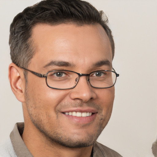 Joyful white adult male with short  brown hair and brown eyes