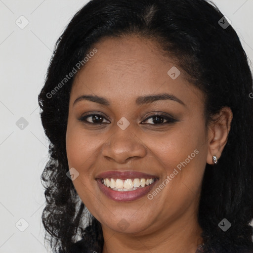 Joyful black young-adult female with long  brown hair and brown eyes