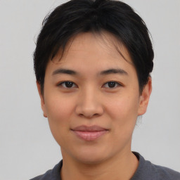 Joyful asian young-adult female with short  black hair and brown eyes