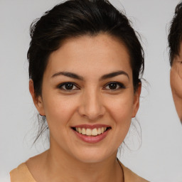 Joyful latino young-adult female with medium  brown hair and brown eyes