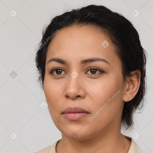 Joyful latino young-adult female with short  black hair and brown eyes