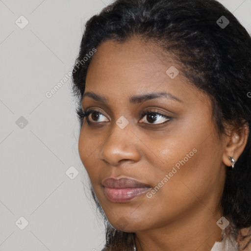 Joyful black young-adult female with long  black hair and brown eyes