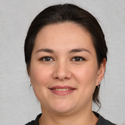 Joyful white young-adult female with medium  brown hair and brown eyes