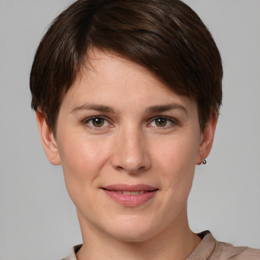 Joyful white young-adult female with short  brown hair and grey eyes