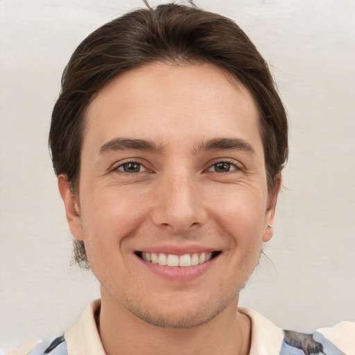 Joyful white young-adult male with short  brown hair and brown eyes