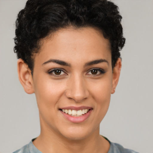 Joyful latino young-adult female with short  brown hair and brown eyes