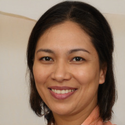 Joyful white adult female with medium  brown hair and brown eyes