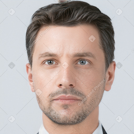 Neutral white adult male with short  brown hair and grey eyes