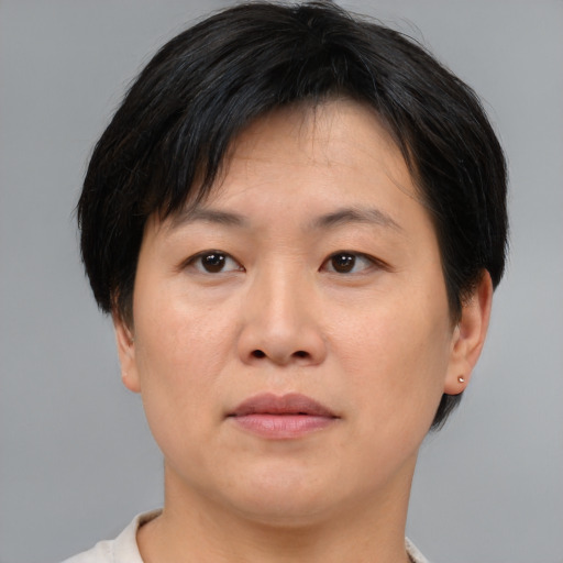 Neutral asian adult female with short  brown hair and brown eyes