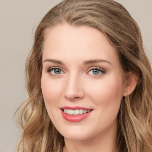 Joyful white young-adult female with long  brown hair and blue eyes