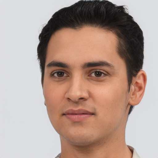 Joyful white young-adult male with short  black hair and brown eyes