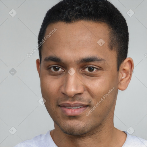 Joyful black young-adult male with short  black hair and brown eyes