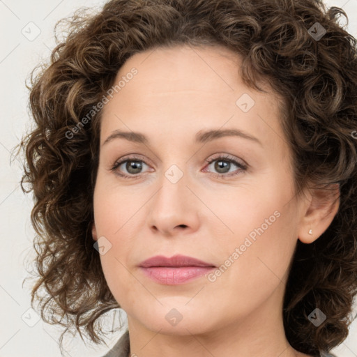 Joyful white young-adult female with medium  brown hair and green eyes