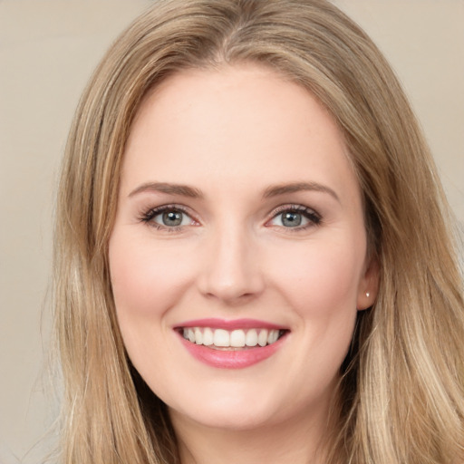 Joyful white young-adult female with long  brown hair and green eyes