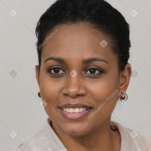 Joyful black young-adult female with short  black hair and brown eyes