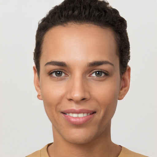 Joyful white young-adult female with short  brown hair and brown eyes