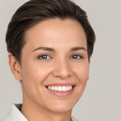 Joyful white young-adult female with short  brown hair and brown eyes