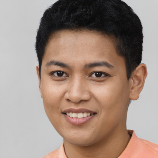Joyful latino young-adult male with short  black hair and brown eyes