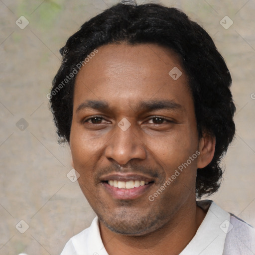 Joyful black adult male with short  black hair and brown eyes