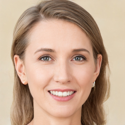 Joyful white young-adult female with long  brown hair and green eyes