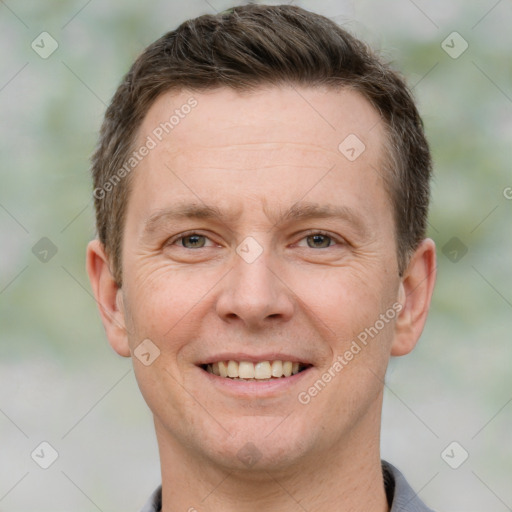 Joyful white adult male with short  brown hair and grey eyes