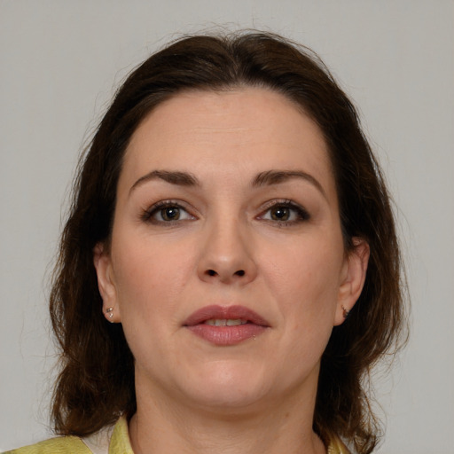 Joyful white young-adult female with medium  brown hair and brown eyes