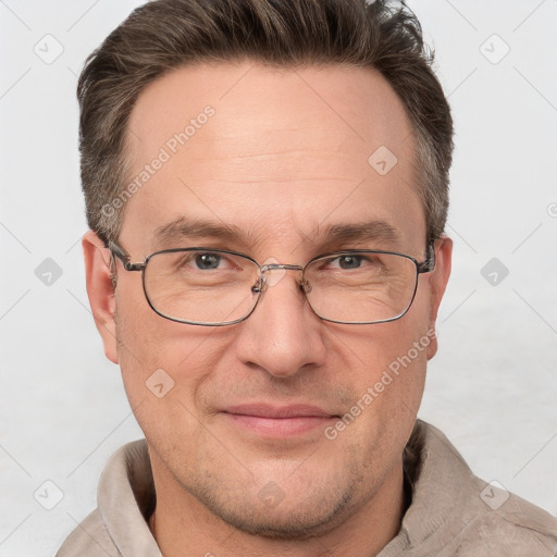 Joyful white adult male with short  brown hair and grey eyes