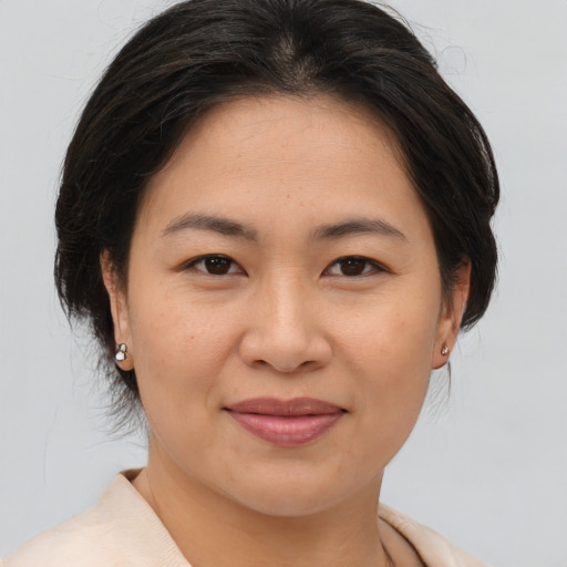 Joyful asian young-adult female with medium  brown hair and brown eyes
