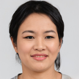 Joyful asian young-adult female with medium  black hair and brown eyes