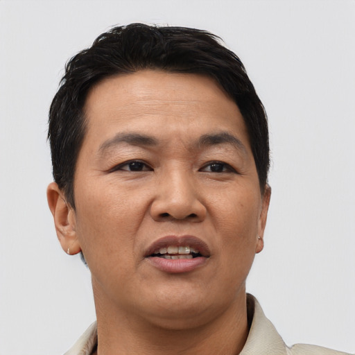 Joyful asian adult male with short  brown hair and brown eyes