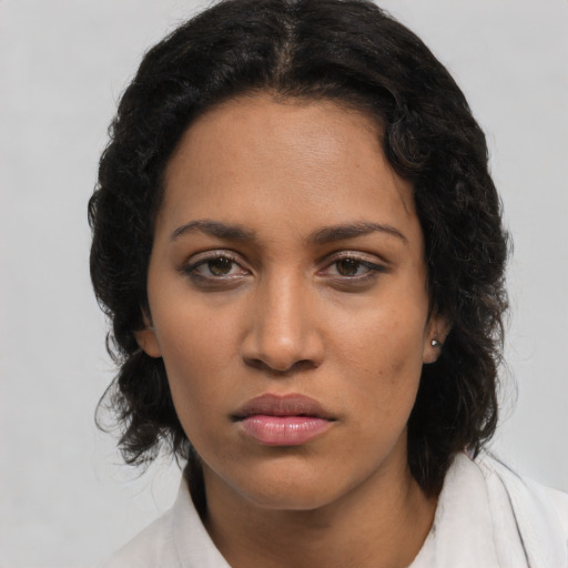 Joyful latino young-adult female with long  brown hair and brown eyes