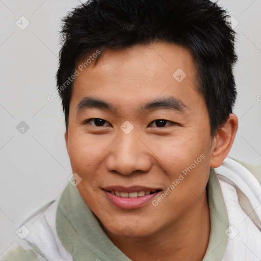 Joyful asian young-adult male with short  brown hair and brown eyes