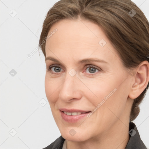 Joyful white adult female with medium  brown hair and grey eyes