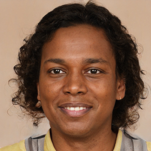 Joyful latino adult female with medium  brown hair and brown eyes