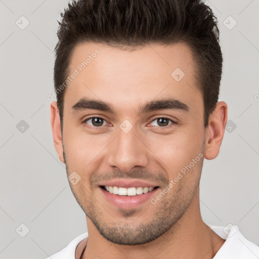 Joyful white young-adult male with short  brown hair and brown eyes