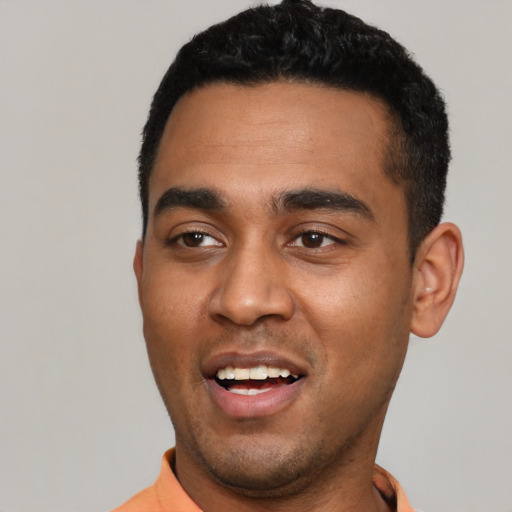 Joyful latino young-adult male with short  black hair and brown eyes